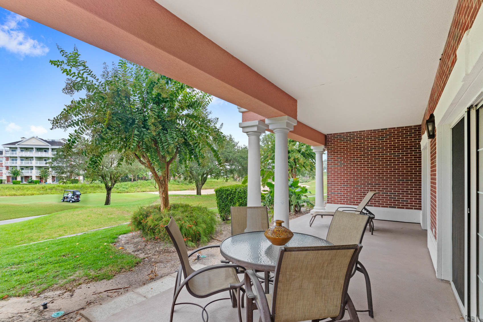back covered patio with table and chairs